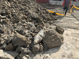 新北市新莊區某連鎖賣場工地4日在整地挖掘地基過程中,挖到一顆疑似未爆彈,工地經理立即報警處理。(圖/民眾提供)